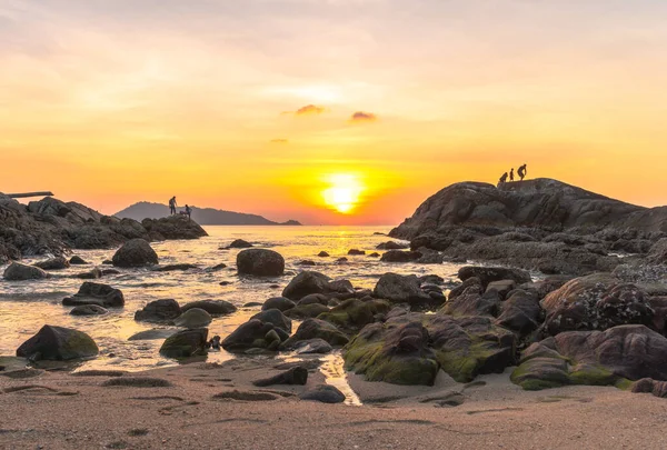 During the sunset, some people come to rest. Some come fishing on the rocks at Kalim Beach, next to Patong Beach, Phuket