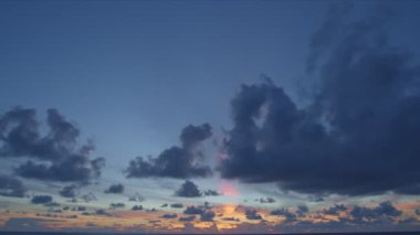 Majestic sunset or sunrise landscape Amazing light of nature cloudscape sky and clouds moving away rolling. 4k colorful dark sunrise clouds above the ocean. 