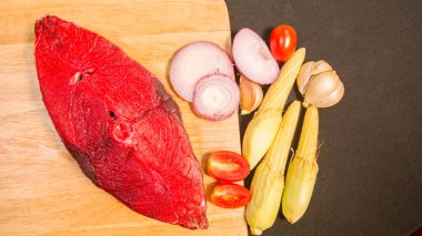 top view fresh fish fillet with peppers on a cutting board.Preparing cooking materials. Fresh vegetables,Fresh fish fillets and spices are placed on a preparation table . 