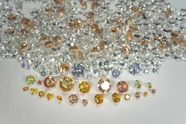 A pile of Yellow sapphire diamonds placed in the center of a white diamonds.