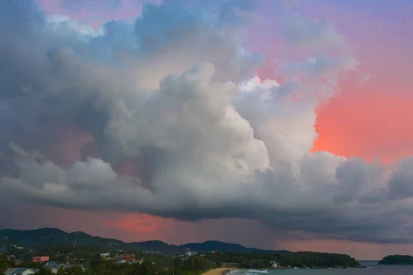 aeriall view scenery sunset above the ocean clouds cover the ocean during colorful cloud in sunset on Karon beach Phuket Thailand. video 4K. Scene of Colorful red light in the sky background.
