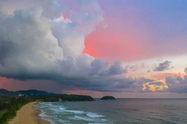 aeriall view scenery sunset above the ocean clouds cover the ocean during colorful cloud in sunset on Karon beach Phuket Thailand. video 4K. Scene of Colorful red light in the sky background.