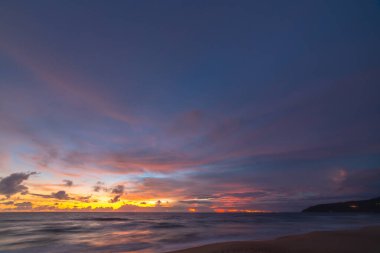  beautiful sunrise above fishing boats It creates a beautiful reflection in the water.scenic reflection of beautiful sunshine in the sea fishing boats are floating in the sea of Phuket