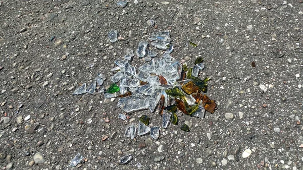 Broken glass fragments on the cement — Stock Photo, Image