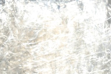 Buruşmuş selofan dokusu. Plastik ışık yansıması arka plan.