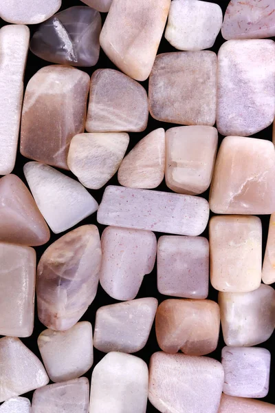 Sunstone heap jewel stones texture background. Pile mineral pebbles nature backdrop.