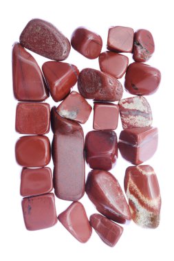 Red jasper heap jewel stones texture on white light background