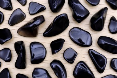 Işık verniklenmiş ahşap zemin üzerindeki obsidyen nadir mücevher taşı dokusu