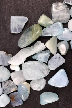 Aquamarine heap up jewel stones texture on black stone background