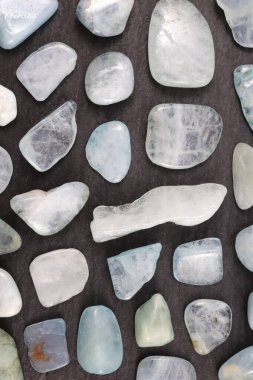 Aquamarine rare jewel stones texture on black stone background