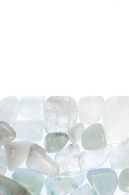 Aquamarine heap jewel stones texture on half white light isolated background. Place for text.