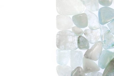 Aquamarine heap jewel stones texture on half white light isolated background. Place for text.
