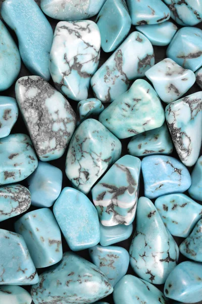 Turquoise heap jewel stones texture on black background