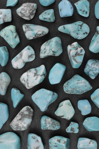 Turquoise rare jewel stones texture on black stone background