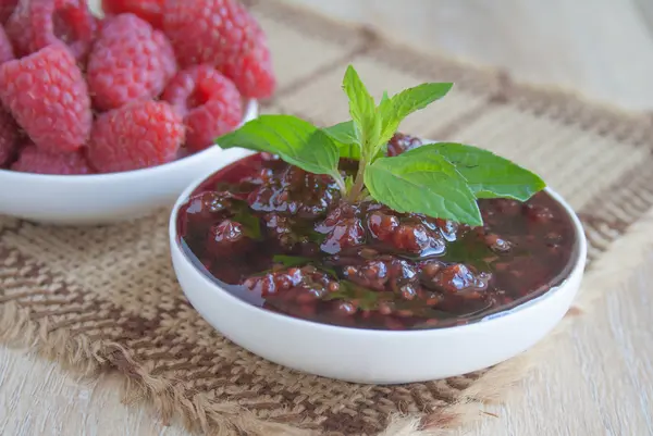 Raspberries and raspberry jam on a beige background — Stock Photo, Image
