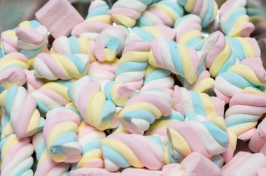 Snack bar cart with colorful and flavored candies and sweets, marshmallows, and fruit jellies for parties and events to serve in small cups. 