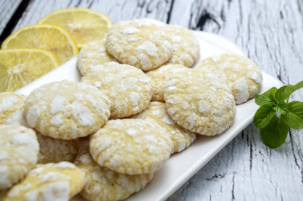 Çikolata, limon ve nane aromalı kurabiyeler ve beyaz tabakta şekerli kırmızı kadife kurabiyeler. Yemek stili.  