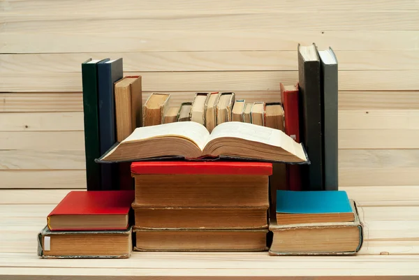 Libro abierto, pila de libros de tapa dura sobre mesa de madera. De vuelta a la escuela. Copiar espacio — Foto de Stock