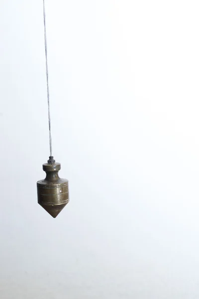 Metal plummet hanged on a rope. — Stock Photo, Image
