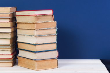 Ahşap masa üzerinde ciltli kitap yığını. Okula dönüş. Kopya alanı