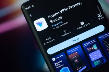 Dhaka, Bangladeş 07 Aralık 2025: Proton vpn logosu akıllı telefon ekranında gösteriliyor ve proton vpn web sitesi arka plandaki bilgisayar ekranında görülebiliyor.