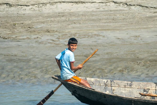 Dhaka, Bangladeş 16 Ocak 2026: Güneşli bir günde teknede kürek çekerken gülümseyen çocuk