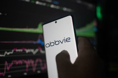 Dhaka, Bangladeş 20 Şubat 2026: Abbvie 'yi bir arkaplan borsa grafiklerine karşı gösteren akıllı telefon veri analizi öneriyor