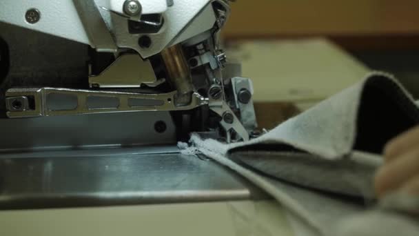 Una costurera trabaja en una máquina de coser industrial. — Vídeos de Stock