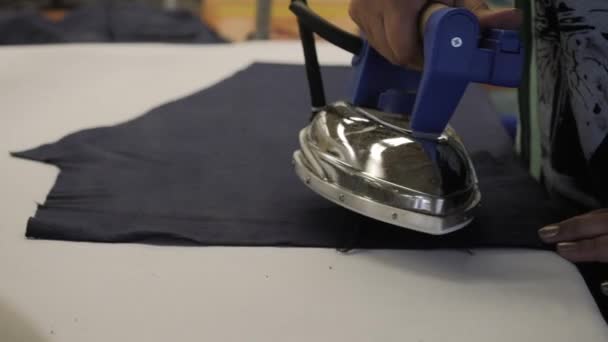 A woman steams clothes with an industrial iron. — Stock Footage A woman steams clothes with an industrial iron. Royalty Free Stock Footage