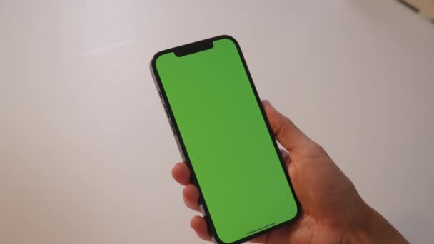 Das Mädchen berührt mit den Fingern den grünen Bildschirm des Smartphones — Stockvideo