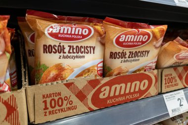SAVAŞ, POLAND - 21 HAZİRAN 2026 Amino marka tavuk çorbası paketleri süpermarket rafında geri dönüşümlü karton bir kutuda sergileniyor.