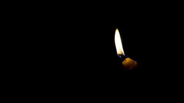 Brennende Kerze auf dunklem Hintergrund — Stockfoto