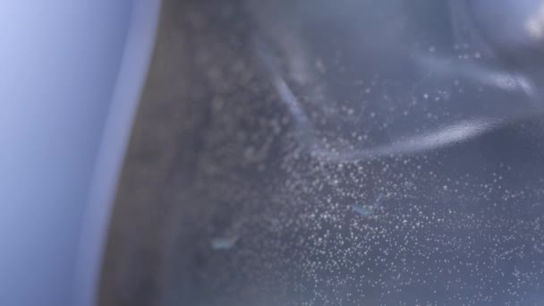 Closeup of ice in a glass with bubbles — Stock Video