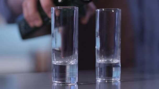 Shot glass filling with a liquid — Stock Video