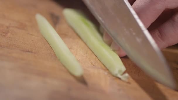 Close-up van snijden komkommer op een snijplank — Stockvideo