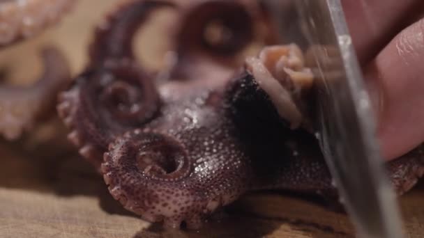 Nahaufnahme von schneidendem Oktopus auf einem Schneidebrett — Stockvideo