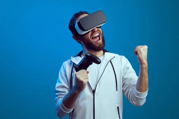 Young excited bearded man standing with the VR equipment and playing — Stock Photo, Image