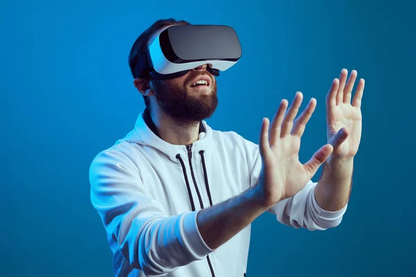 Amazed young bearded man touching the air during the VR experience — Stock Photo, Image