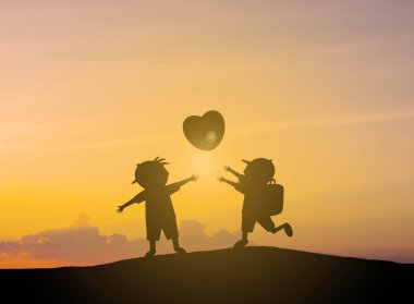 gün batımı ile balon şeklinde kalp siluet çocuklar oynar