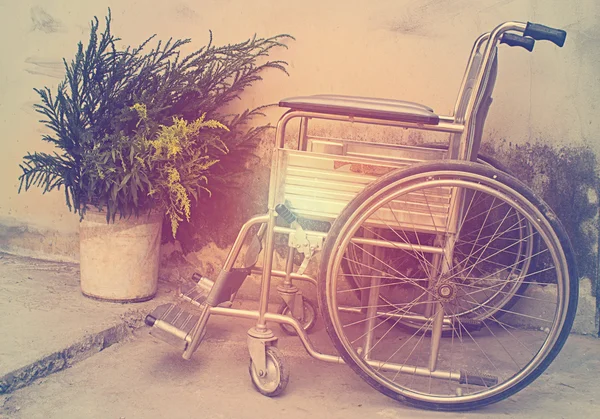 Vintage,Old Wheelchairs with wall background