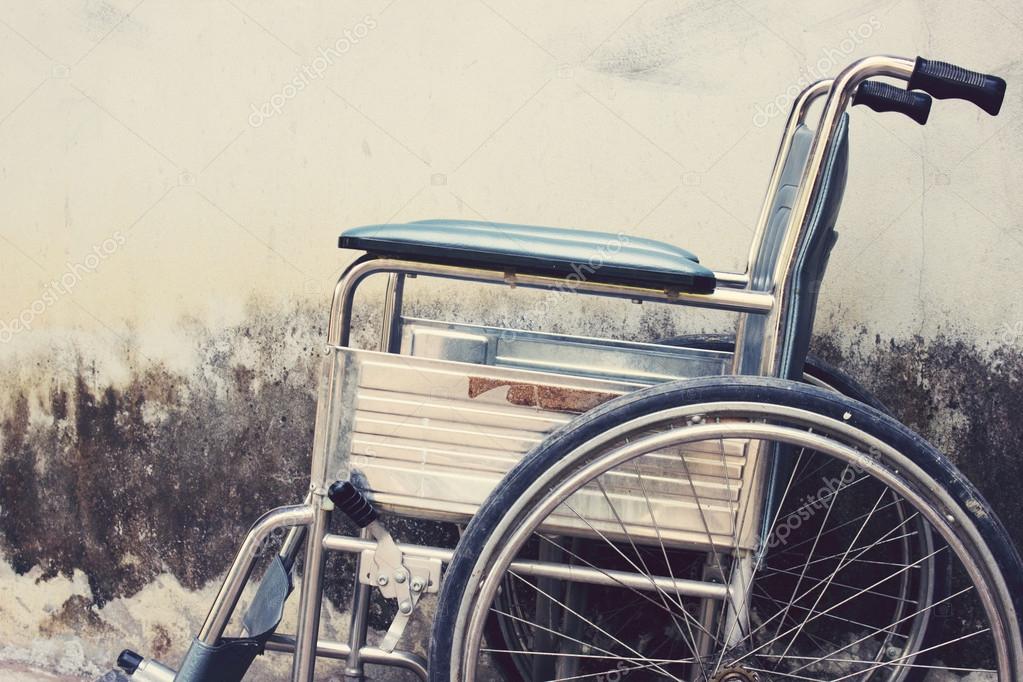 Vintage,Old Wheelchairs with wall background Stock Photo by ©art-artis
