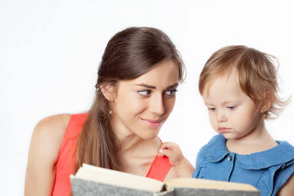 Mother is reading a book with her daughter Royalty Free Stock Images