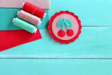 Felt brooch hand embroidered summer. Felt cherry ornament. Set of multicolored threads. Set of colored felt sheets. clipart
