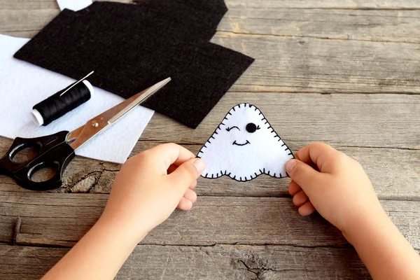 Cute white ghosts crafts, felt sheets, scissors, thread, needles