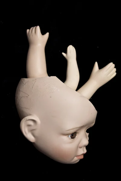 Close Up di teste e parti di bambola rotte su sfondo nero — Foto Stock