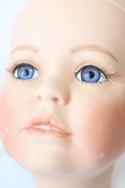 Close Up of Broken Doll Heads On White Background