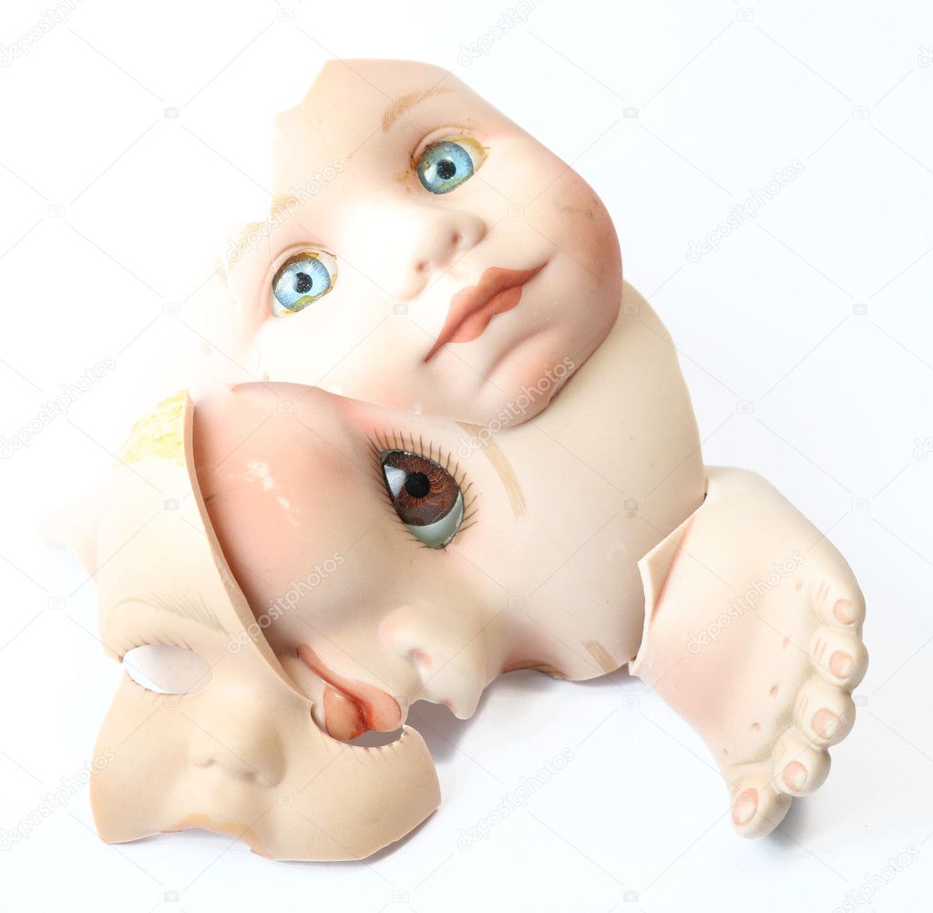 Close Up of Broken Doll Heads On White Background