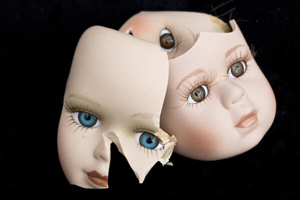 Broken Doll Body Parts on Black Background