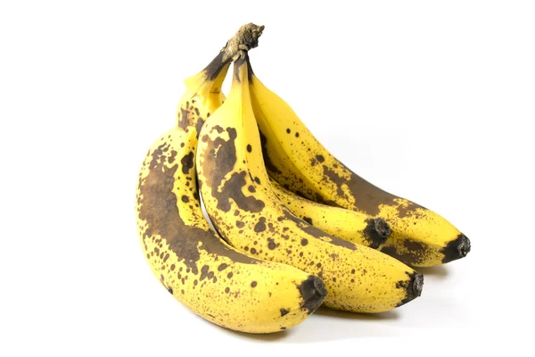 Zralé banány a kůži na bílém pozadí — Stock fotografie
