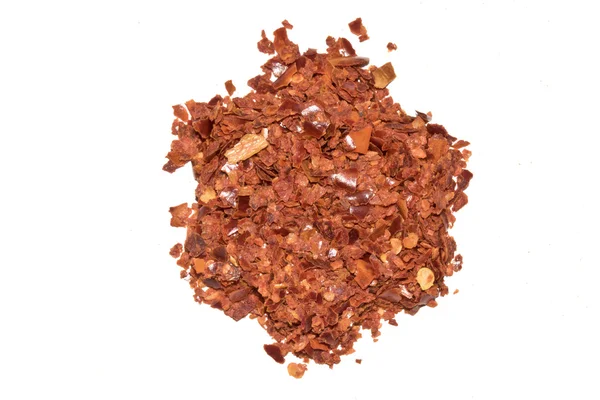 Röd chili krydda flingor på vit bakgrund — Stockfoto